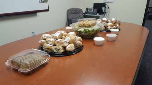 Catering platters set up for an office meeting